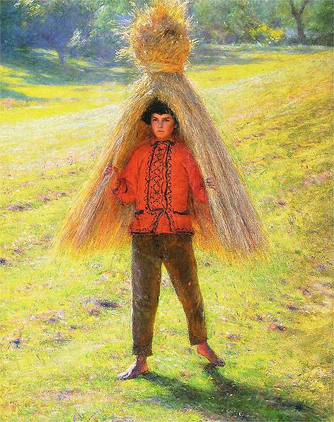 A boy carrying a sheaf